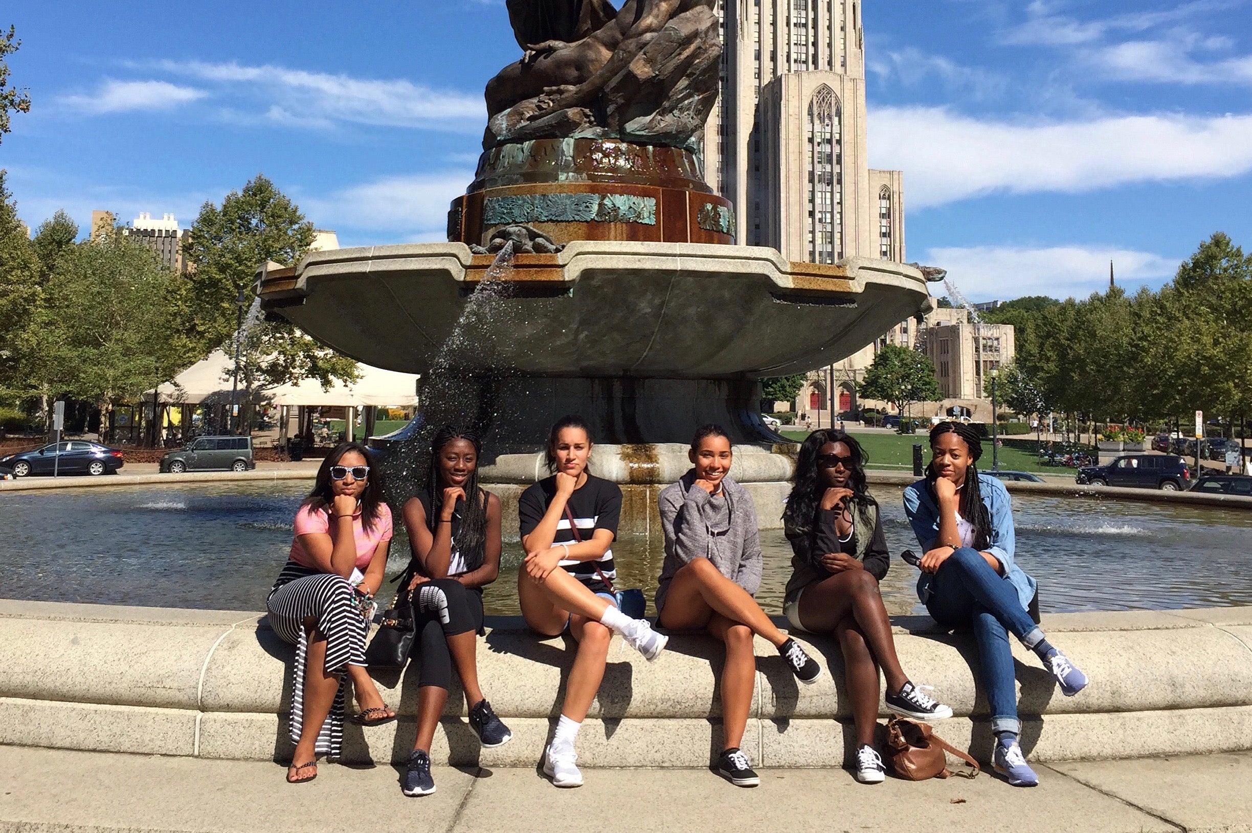 students sitting and posing at a fountain