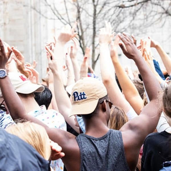 students with their hands up
